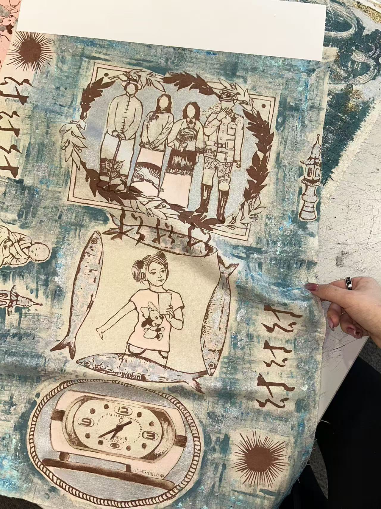 A hand-printed textile collage with figures, fish and clocks